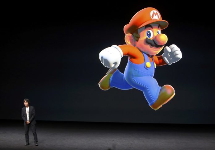 Nintendo Creative Fellow Shigeru Miyamoto stands next to the Super Mario character during an Apple media event in San Francisco, California, U.S. September 7, 2016.  REUTERS/Beck Diefenbach