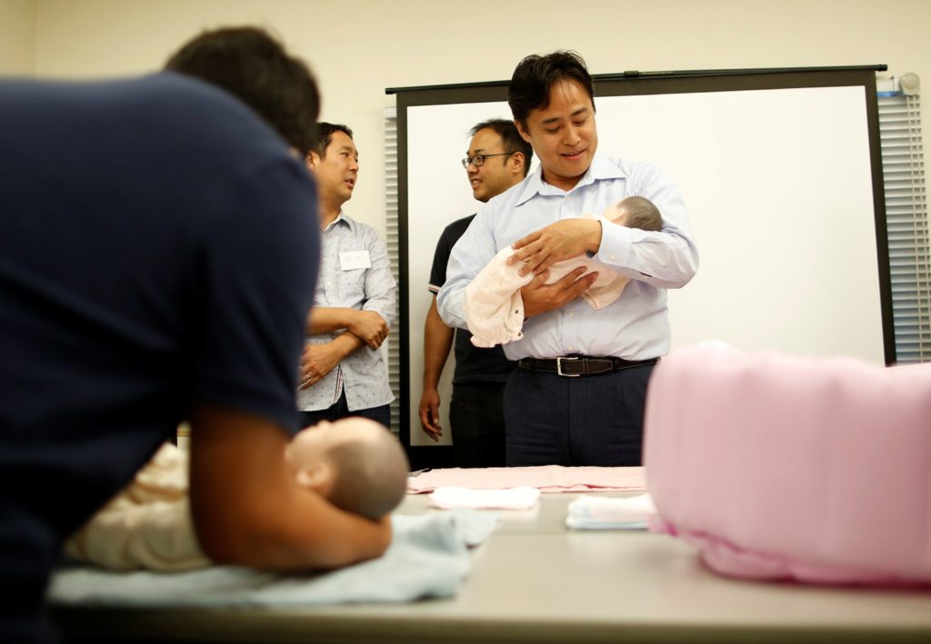 Yuji Inoue (R), 42, and other participants take part in an "Ikumen" course, or child-rearing course for men, organized by Osaka-based company Ikumen University, in Tokyo, Japan September 18, 2016. Picture taken September 18, 2016. REUTERS/Issei Kato