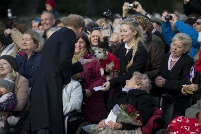 Britain's Prince Harry greets wellwishers after attending a Christmas Day church service at St Mary Magdalene Church in Sandringham, Norfolk, eastern England on December 25, 2016. / AFP PHOTO / Justin TALLIS